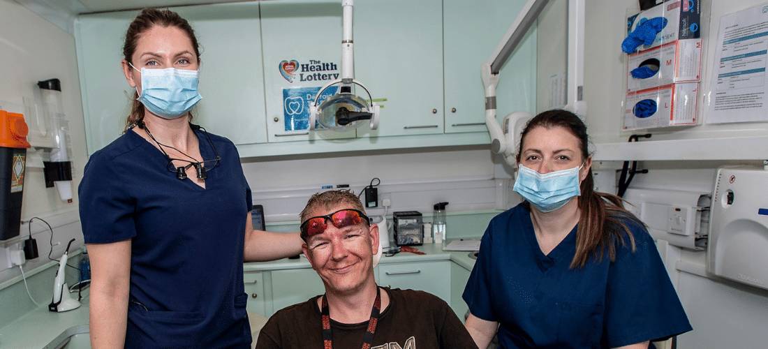 Photo of two dental nurses and a patient following dental clinic