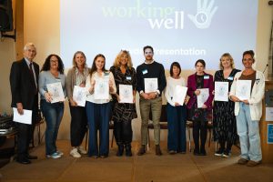 An image of award winners holding their certificates at Duchy Health Charity's Working Well Conference