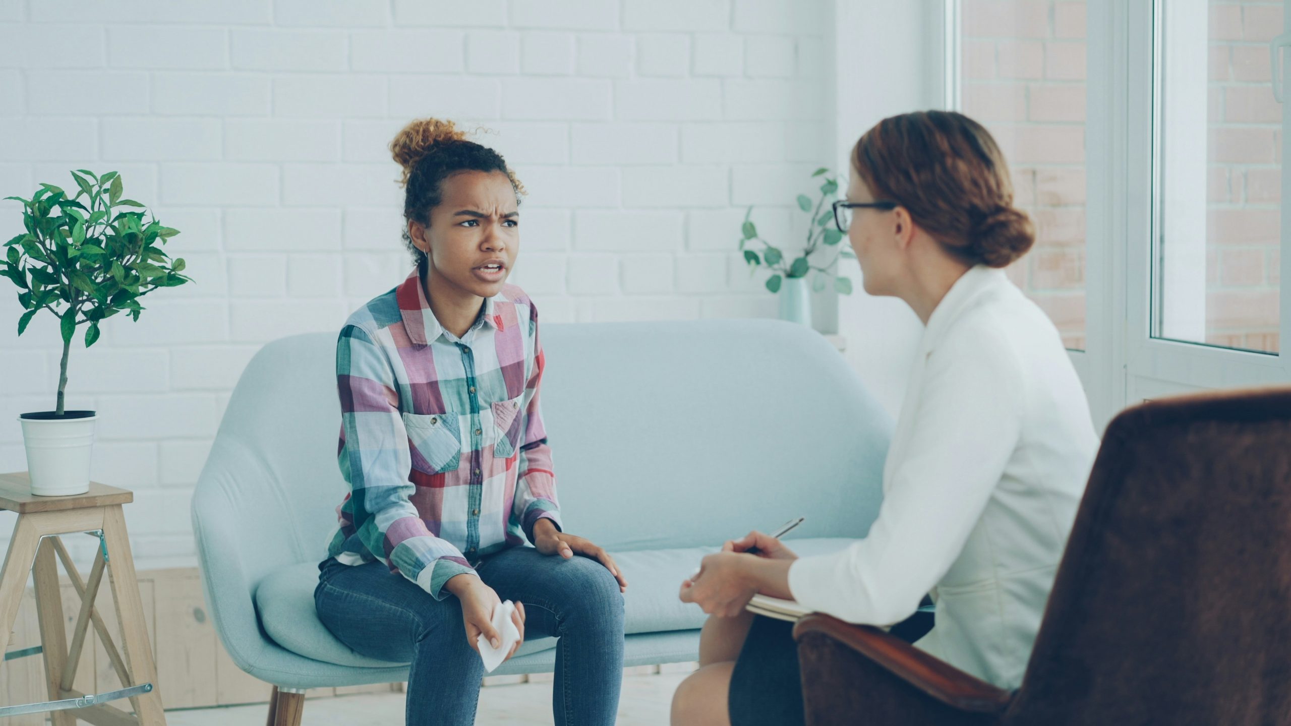 An image of a young woman during a counselling session.