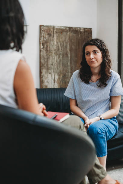 An image of a counselling session showing a woman talking to her counsellor in the studio.