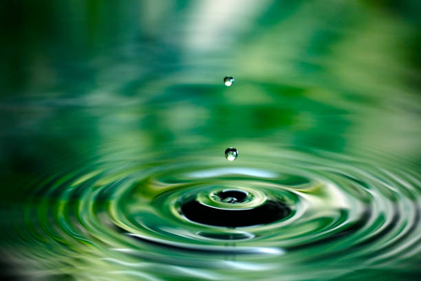 Water droplets and ripples falling on the surface of the water