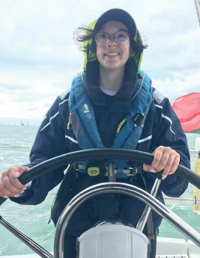 An image of a young person steering a sailing boat