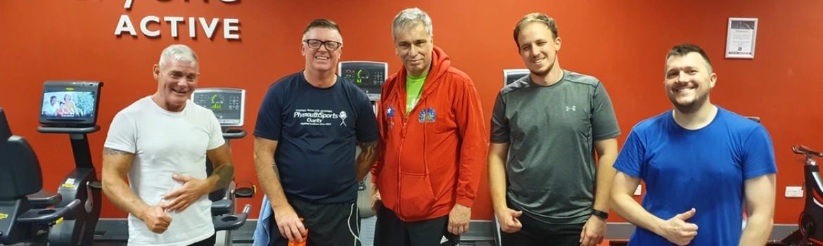 An image of five men of various ages wearing gym clothing